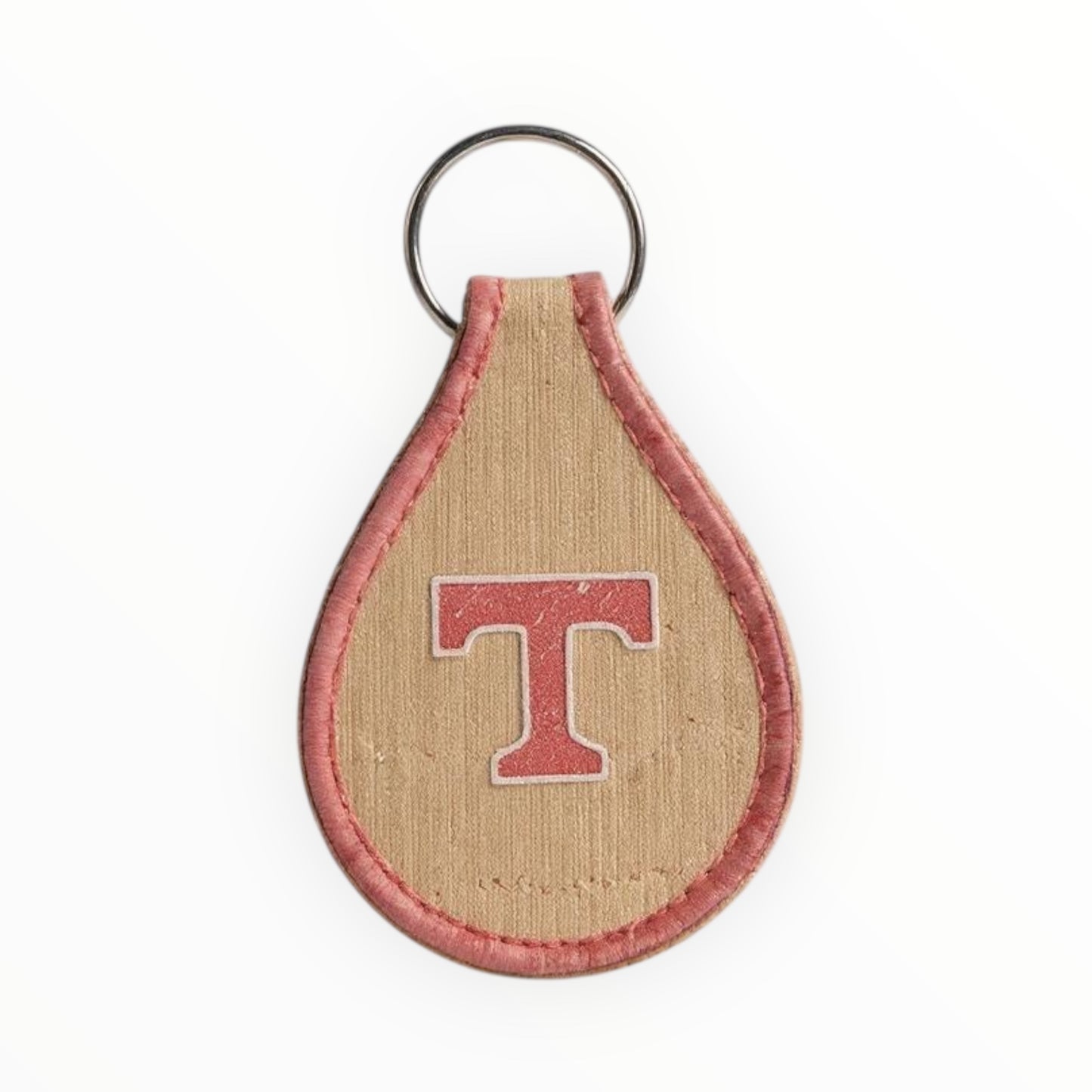 Keychain with a letter 'T' on a beige and red background