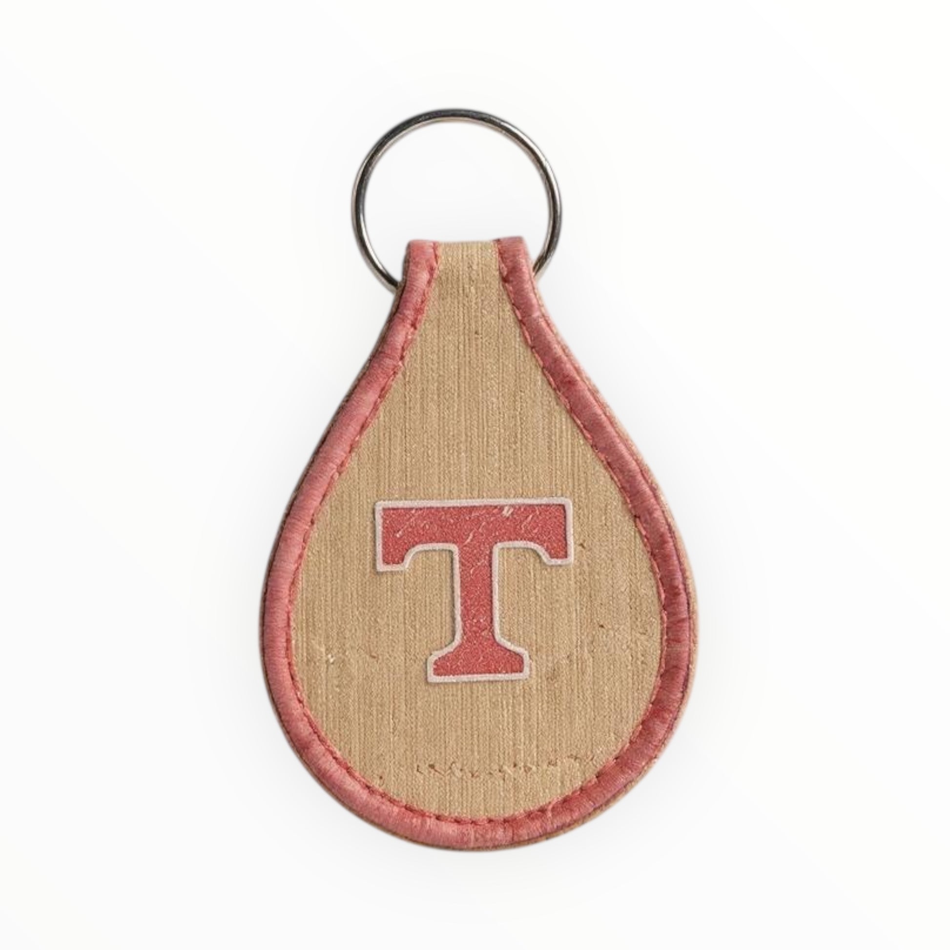 Keychain with a letter 'T' on a beige and red background