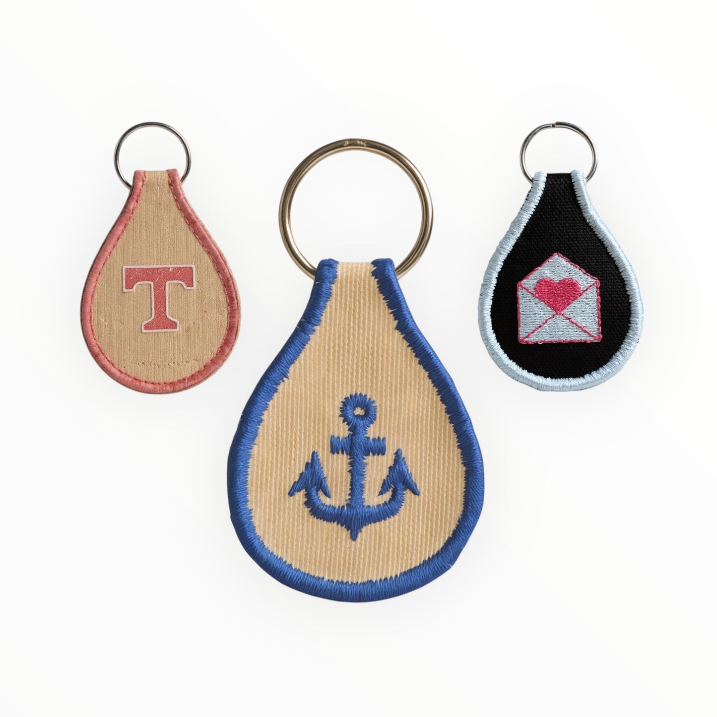 Three keychains with different designs on a white background