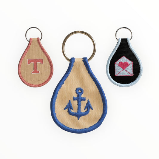 Three keychains with different designs on a white background