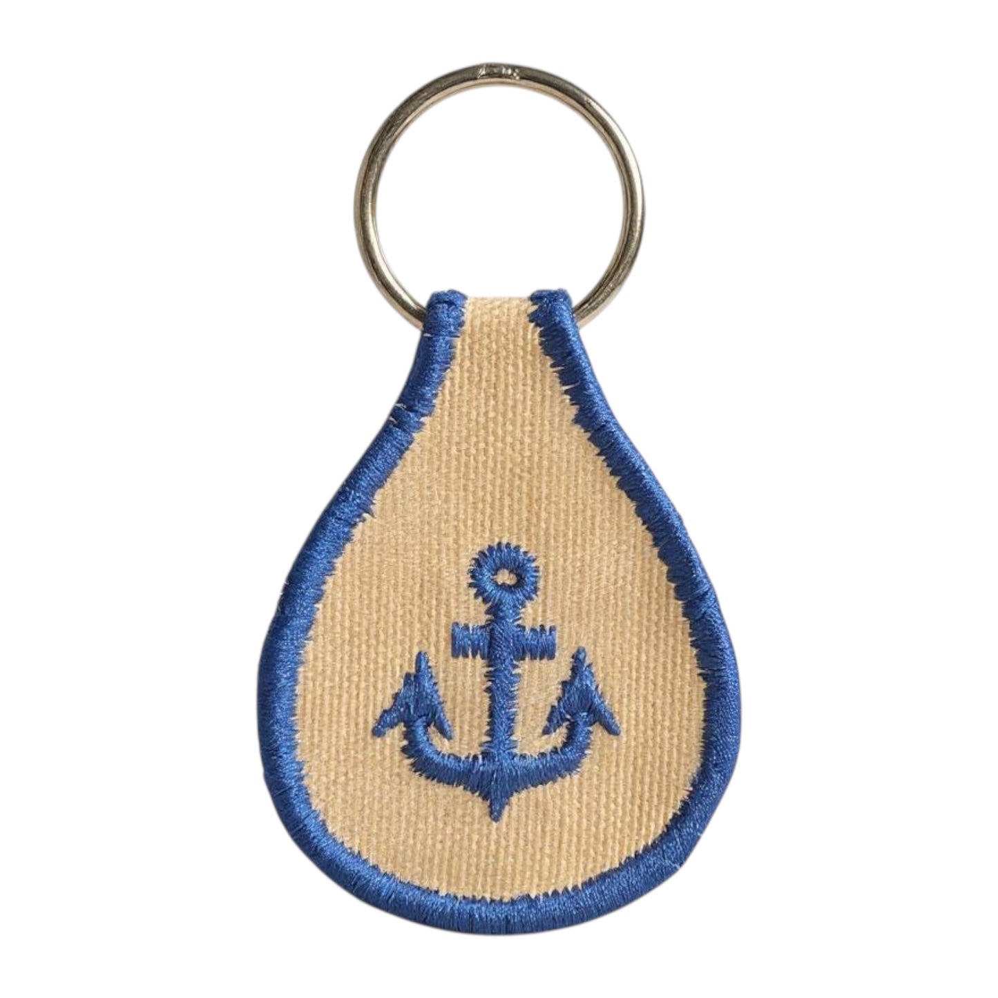 Keychain with anchor design on a beige and blue fabric background
