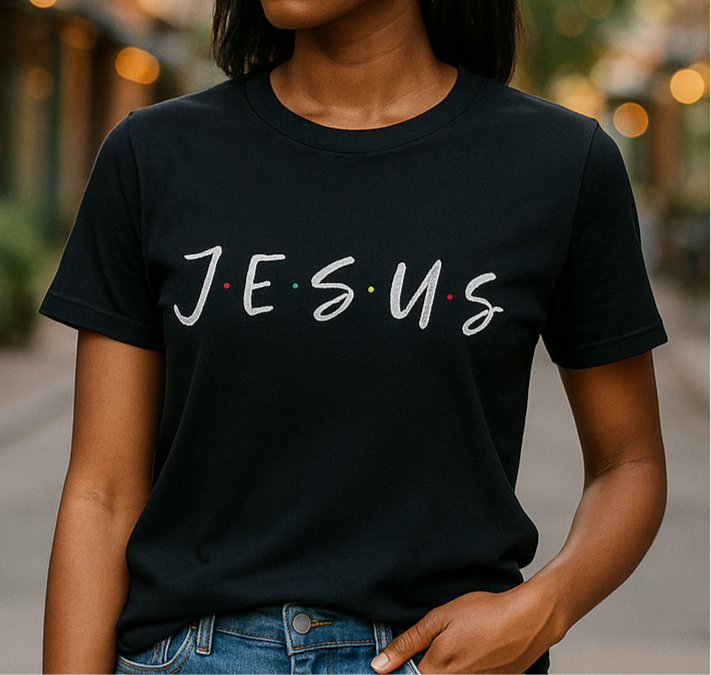 Person wearing a black t-shirt with 'JESUS' printed on it.