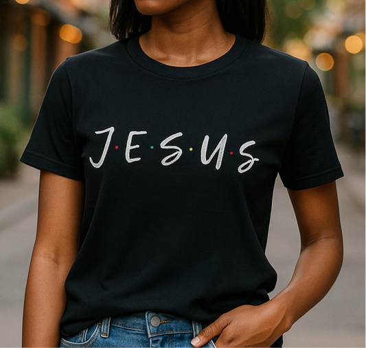 Person wearing a black t-shirt with 'JESUS' printed on it.