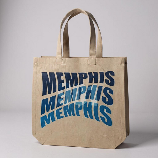 Beige tote bag with 'MEMPHIS' text in blue on a gray background
